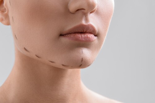 a woman's face with dashed along her chin and jaw